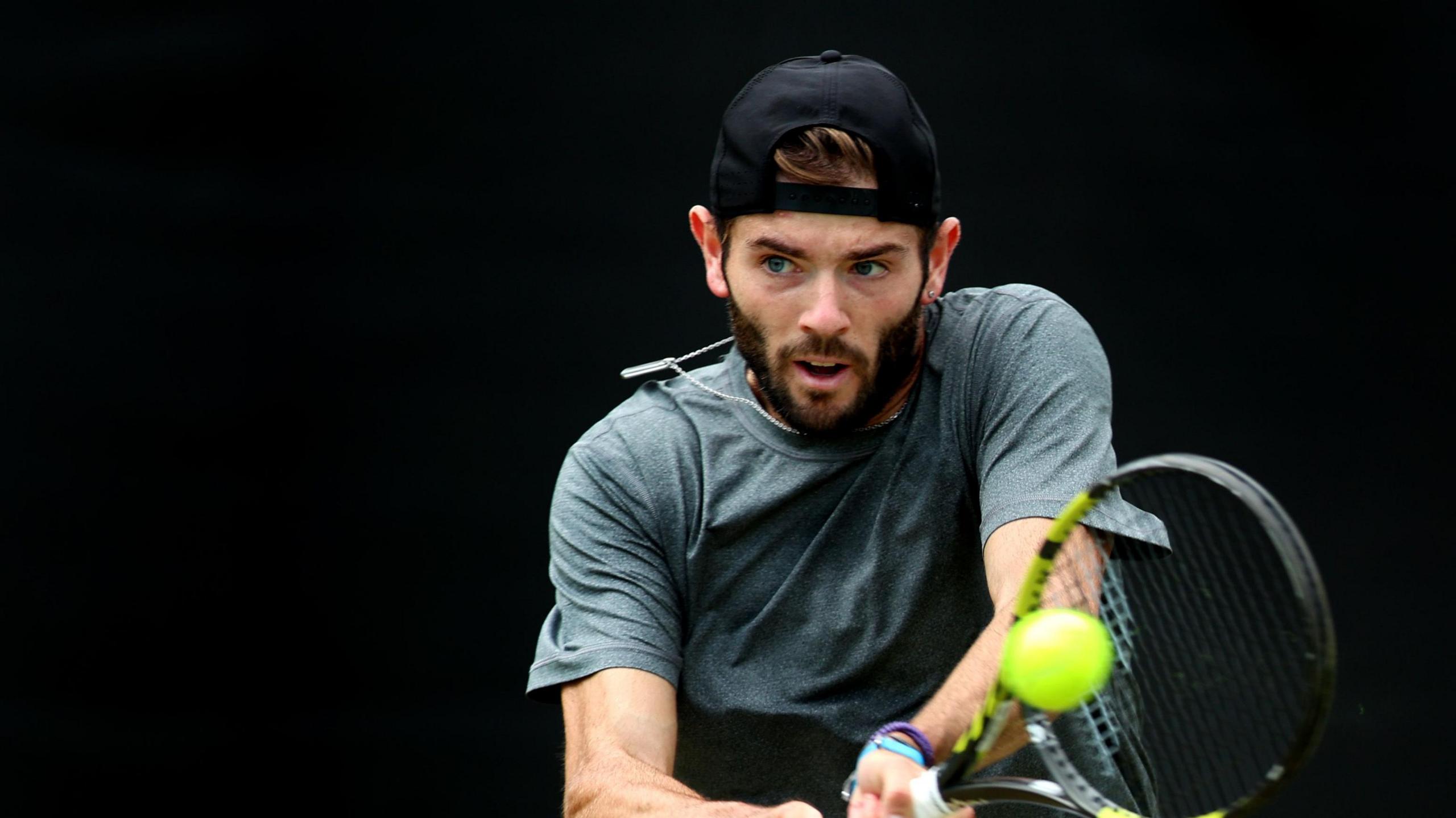 Jacob Fearnley hits a backhand return