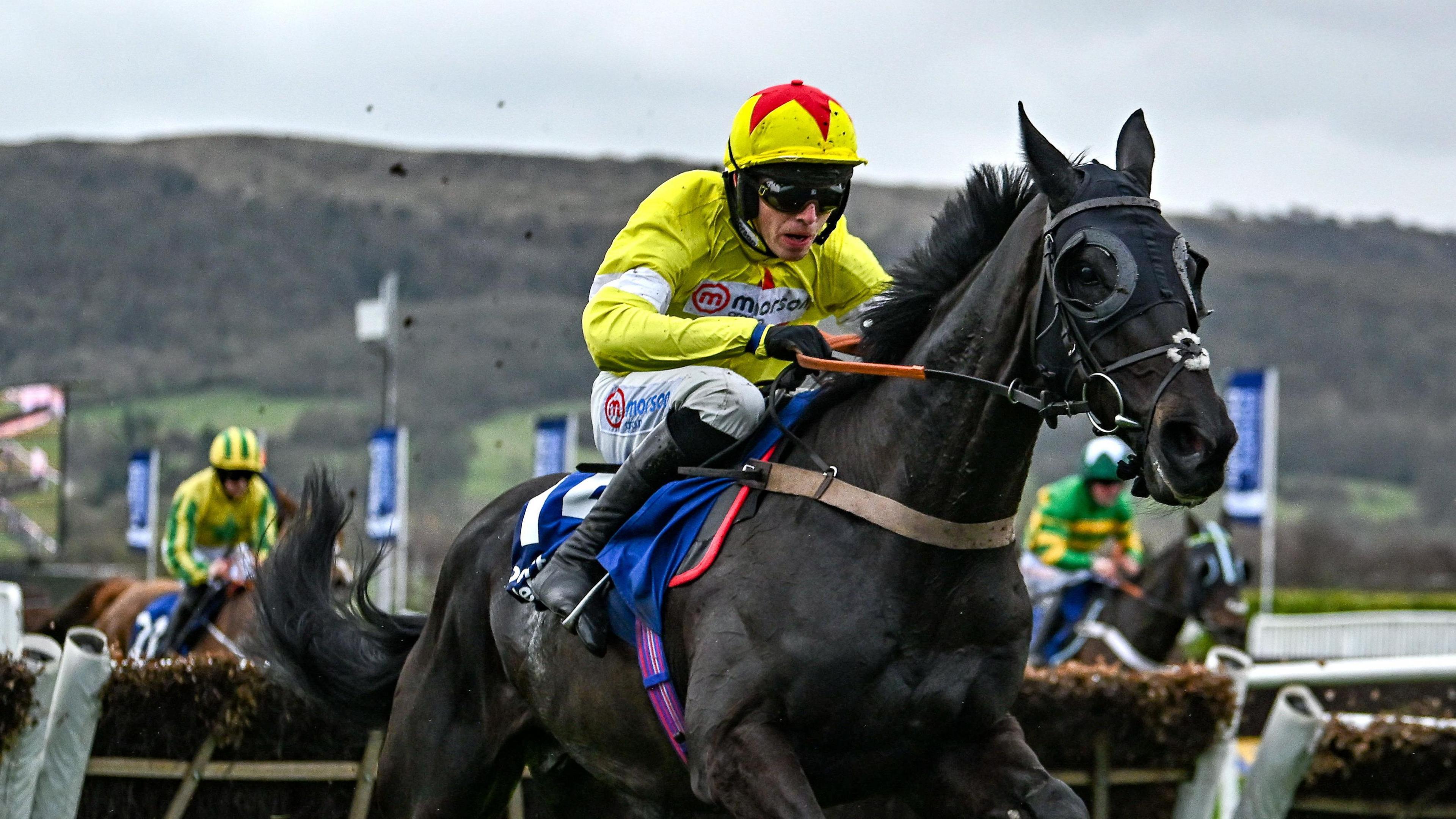 Harry Cobden riding Monmiral to victory in the Pertemps Handicap Hurdle at the 2024 Cheltenham Festival