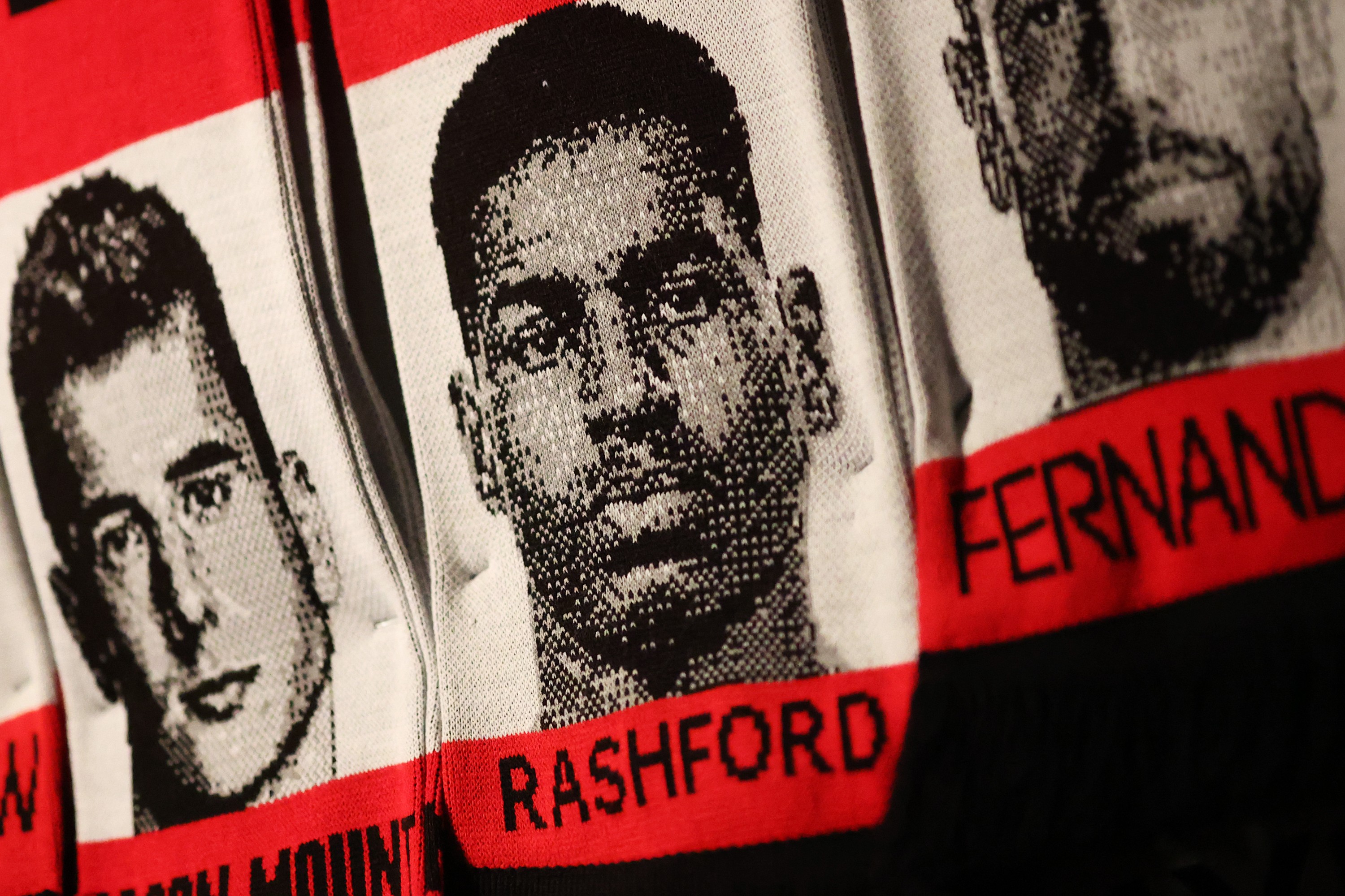 Scarf displays with headshots of Manchester United players including Marcus Rashford